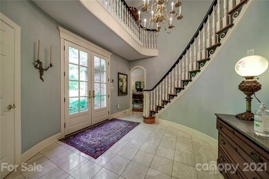 Entry hall/foyer with a curved staircase. Two wedd