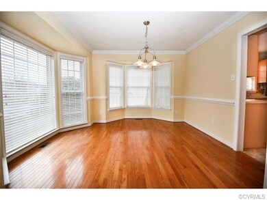 The formal dining room features gleaming floors an