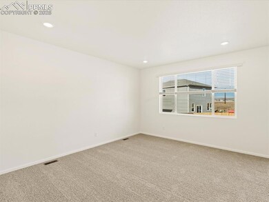Carpeted spare room with baseboards and recessed lighting
