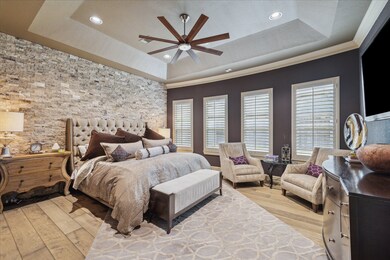 Alluring primary suite featuring stacked stone acc