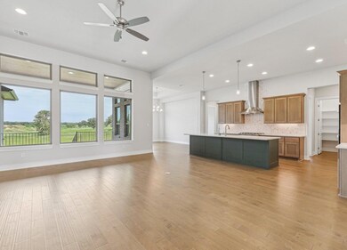 Kitchen featuring light countertops, open floor p