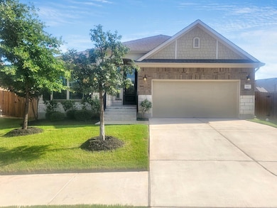 Craftsman inspired home featuring a garage, drive