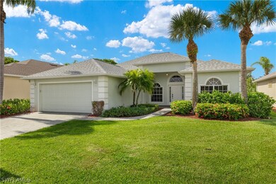 View of front of property with a garage and a front yard