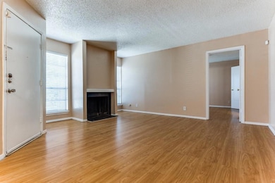 Unfurnished living room with a textured ceiling an