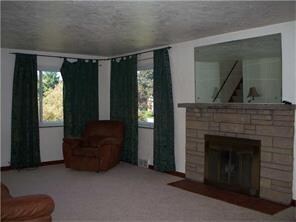 Hardwood floors underneath carpeting and woodburni