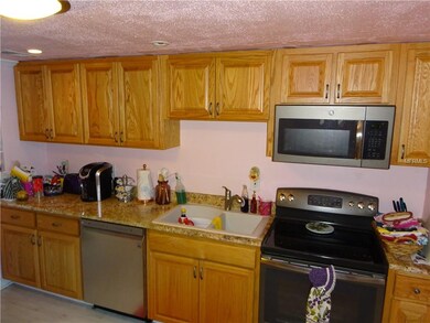 New kitchen with wood cabinets, granite and SS app