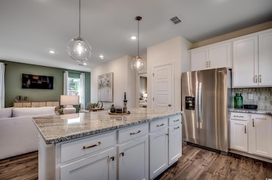 Kitchen with stainless steel refrigerator with ice
