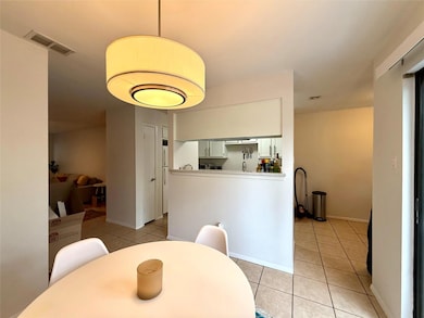 Dining area featuring light tile patterned floors