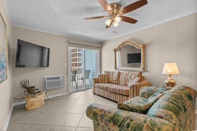 Living room featuring crown molding, an AC wall unit, tile patterned flooring, a textured ceiling, and ceiling fan