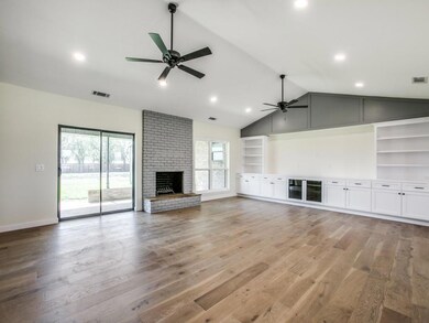 Large living room with tons of natural light and custom cabinets and shelves
