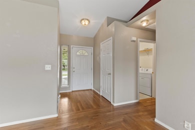 Entryway featuring washer / clothes dryer and wood finished floors