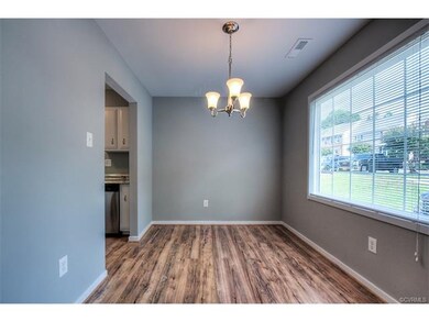 The formal dining room has new flooring, fresh pai