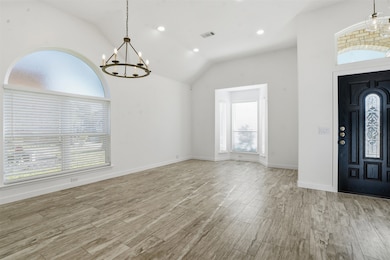 Formal Dining and Foyer featuring a chandelier, recessed lighting, light wood-style ceramic flooring, and vaulted ceiling
