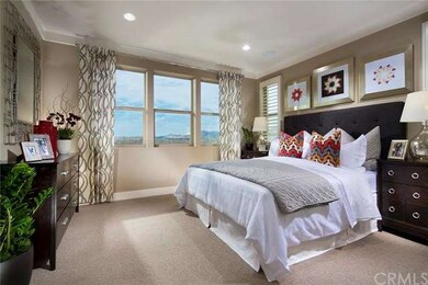 Luxurious master bedroom is light and bright, as s
