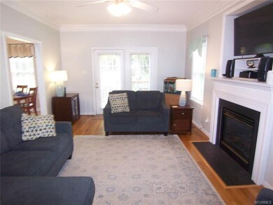 Family room with hardwood floors, ceiling fan, gas