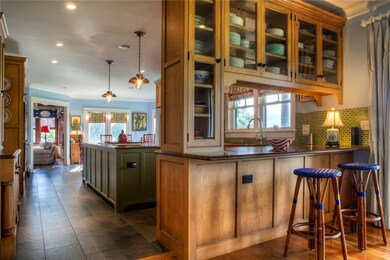 Kitchen with barstools at peninsula-granite counte
