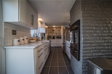 Galley kitchen with Carrera Marble countertops, Bu
