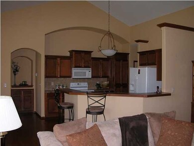 The kitchen offers plenty of cabinets, countertop 