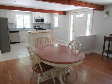 Eating area with oak flooring abuts...