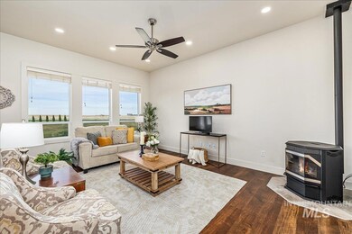 Living area featuring a pellet stove, recessed lighting, dark wood-style floors, and a ceiling fan