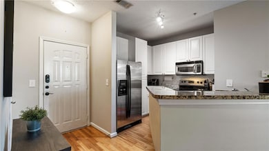 Kitchen featuring decorative backsplash, white cab