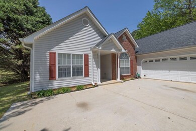 View of front of home with an attached garage, con