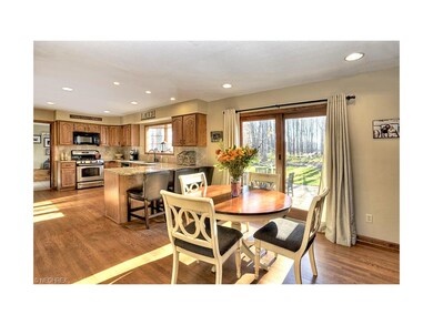 Light-filled kitchen with hardwood flooring and sl