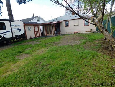 The back yard features lots of room for storage, i