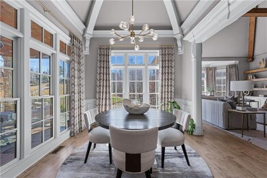 Dining area with beamed ceiling, a wainscoted wall