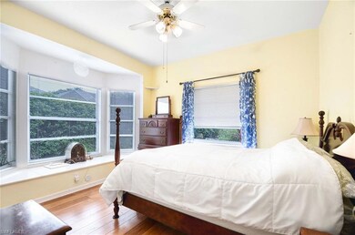 Bedroom with hardwood / wood-style floors and ceiling fan