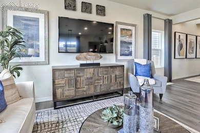 Living area featuring baseboards and wood finished floors