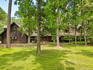 Stunning front yard view of custom log cabin surro