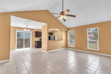 Unfurnished living room featuring ceiling fan, li