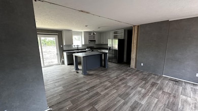 Kitchen featuring dark countertops, open shelves, 