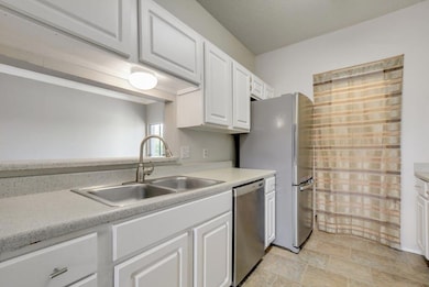 Kitchen with light countertops, stainless steel a