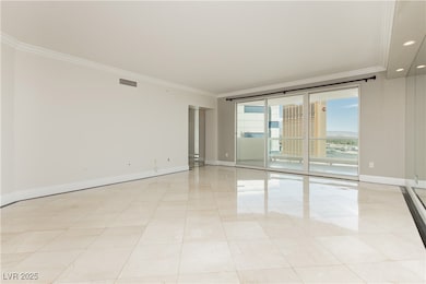 Empty room featuring baseboards, visible vents, an