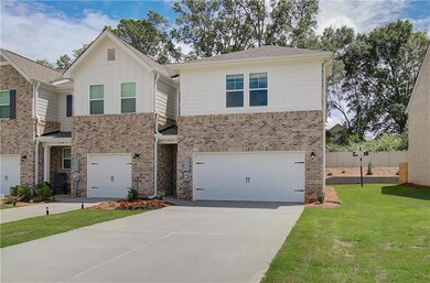 View of front of house with a garage and a front y