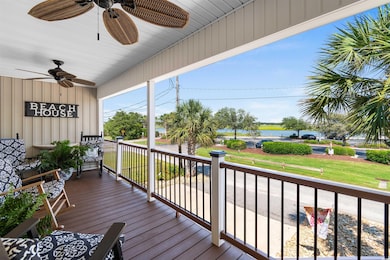Wooden terrace featuring ceiling fan, a porch, and