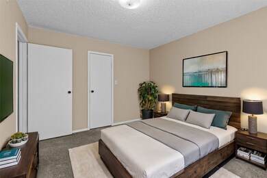 Virtually stagged primary suite has walk-in closet