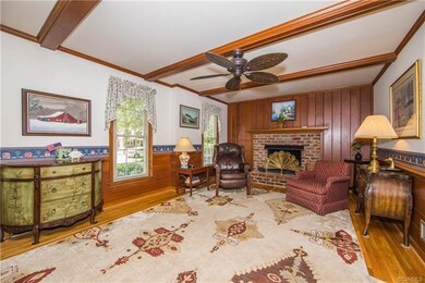 Family Room has brick fireplace with gas logs, har