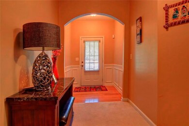 Doorway with arched walkways, light colored carpet