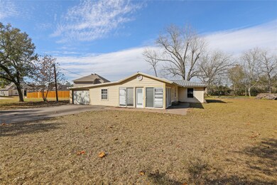 View of the fixer-upper home on the property.