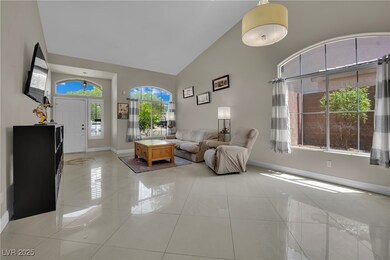 Living area with high vaulted ceiling, baseboards,