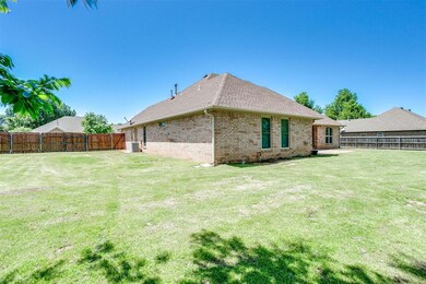 Rear view of property with a yard