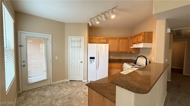 Kitchen featuring white appliances, under cabinet
