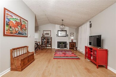 Living area with brick fireplace and wood stove, v