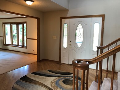 Large 2 story foyer with hardwood floors, a newer 
