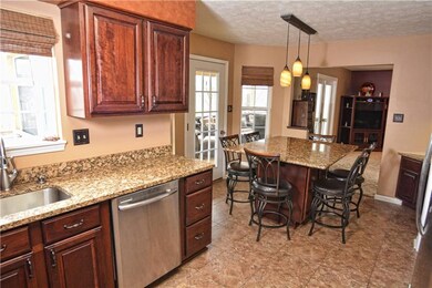 Tile flooring, ample cabinetry, granite counter to
