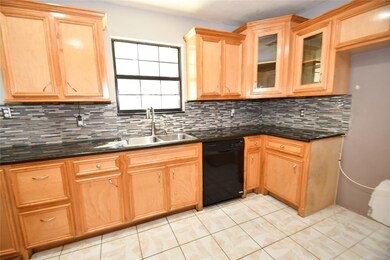 Kitchen with multicolor tile.
