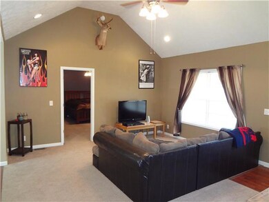 This great living room offers a cathedral ceiling and plenty of room to enjoy time with the family. 